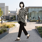 Trendy black and white abstract print baggy shirt, worn by a mannequin in a bright outdoor environment.