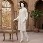Mannequin wearing an elegant ivory embroidered long coat from ZH2 Store, standing next to a vintage wooden chair.