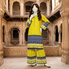 A mannequin wearing a vibrant lime yellow and blue 2-piece unstitched cotton lawn suit with traditional geometric patterns and a chunri border, displayed in a historical courtyard setting.