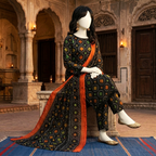 A mannequin seated, showcasing the detailed geometric pattern on the printed lawn shirt and trousers.