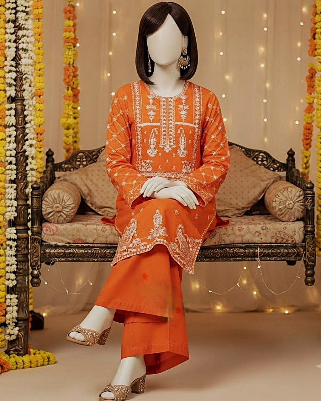 Vibrant orange 2-piece unstitched embroidered lawn suit with matching trousers displayed on a mannequin.