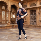 Stylish navy blue baggy shirt with oversized floral print, showcased on a mannequin in a heritage architectural setting.