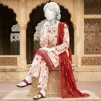 A seated mannequin highlighting the intricate floral pattern and the detailed lace trim on the hem of the silk suit.