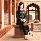 "Model wearing black 2-piece unstitched printed cotton silk suit featuring multicolor leaves, seated view - ZH2 Store."