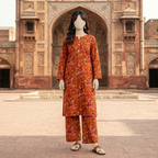 "Woman wearing a rust and orange floral print unstitched cotton silk 2-piece suit"