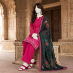 A mannequin sitting on a traditional bench, highlighting the elegant drape of a fuchsia embroidered lawn suit with a 29-inch daman border.