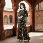 Model wearing a dark green floral printed 2-piece cotton silk unstitched suit by ZH2 Store."