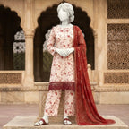 A mannequin displaying the complete 3-piece silk floral suit, emphasizing the coordination between the printed shirt, trousers, and the bold red dupatta.