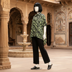 Vibrant green and black patterned baggy shirt, displayed on a mannequin in a classic outdoor setting.