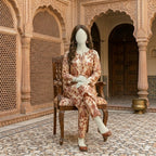 "Mannequin seated in brown printed cotton silk 2-piece suit"