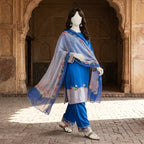 A side view of a mannequin wearing the blue silk floral suit, highlighting the elegant drape and print.