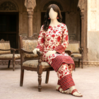 Mannequin seated on a wooden chair showcasing the red and cream floral print on a 2-piece unstitched cotton silk suit.