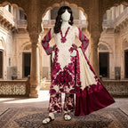 A mannequin featuring a cream-colored silk suit with bold maroon floral patterns, paired with a matching dupatta.