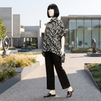 Trendy black and white abstract print baggy shirt, worn by a mannequin in a bright outdoor environment.