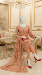 Model wearing a peach 3-piece suit with pearl-embellished embroidery and floral print.