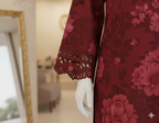 Red floral dress on a mannequin with blurred indoor background