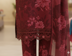 Red floral embroidered outfit on a mannequin with a blurred background