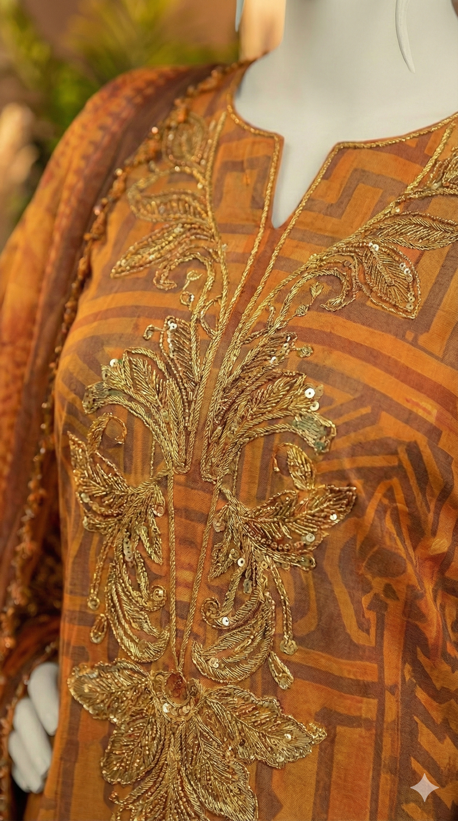 Model in Ochre 3-piece suit with gold tilla embroidered neckline and geometric print.