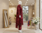 Mannequin wearing a red patterned outfit in a stylish room with decor elements.