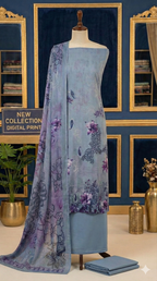 Mannequin wearing a blue dress with a matching floral scarf in a decorative room.