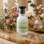 Miss Perfume by ASAAH 50ml frosted glass bottle with mint green label, surrounded by vintage dried roses and lavender on a marble surface.